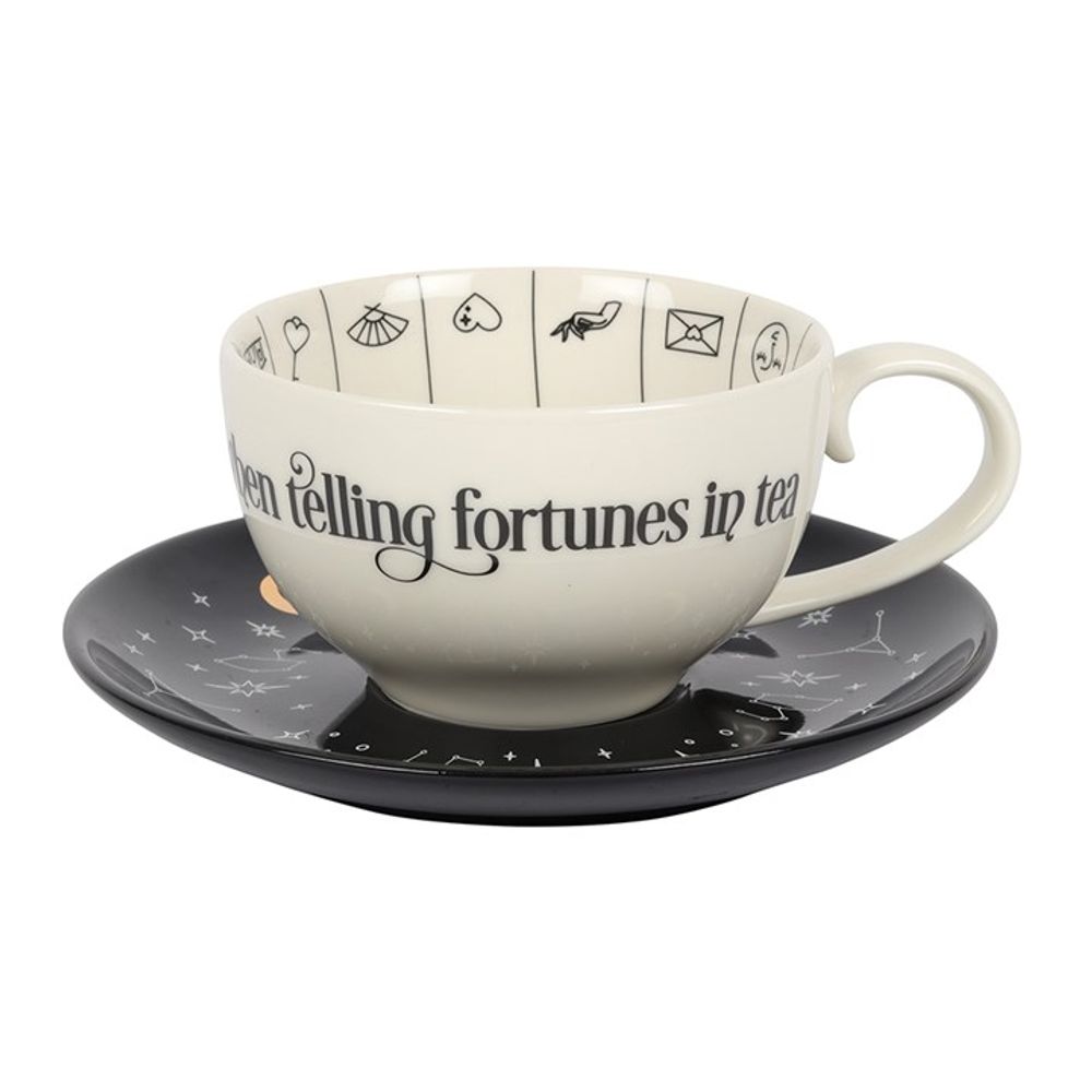 Fortune Telling Ceramic Teacup  A stunning and unique tea cup to be used for reading tea leaves. Features a variety of fortune telling and astrological symbols accented by gold foil, a contrasting black saucer, and mystical 'Mysterious things I see when telling fortunes in tea' text. Truly a piece to be treasured. By Fandomonium