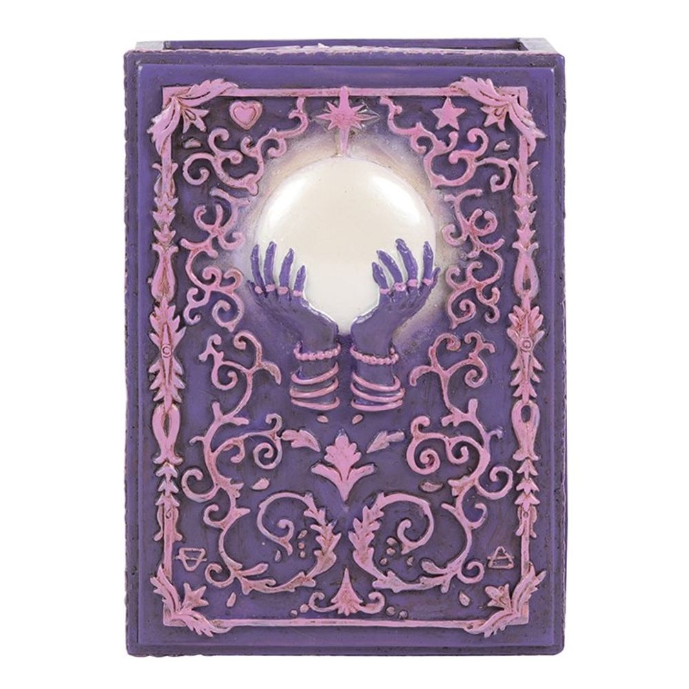 Mystical Crystal Ball Resin Storage Box  A resin box with raised filigree details and a mystical hand and crystal ball design in the center. This pink and purple style is perfect for holding small tarot card decks, crystals, herbs and other small objects for safe keeping.