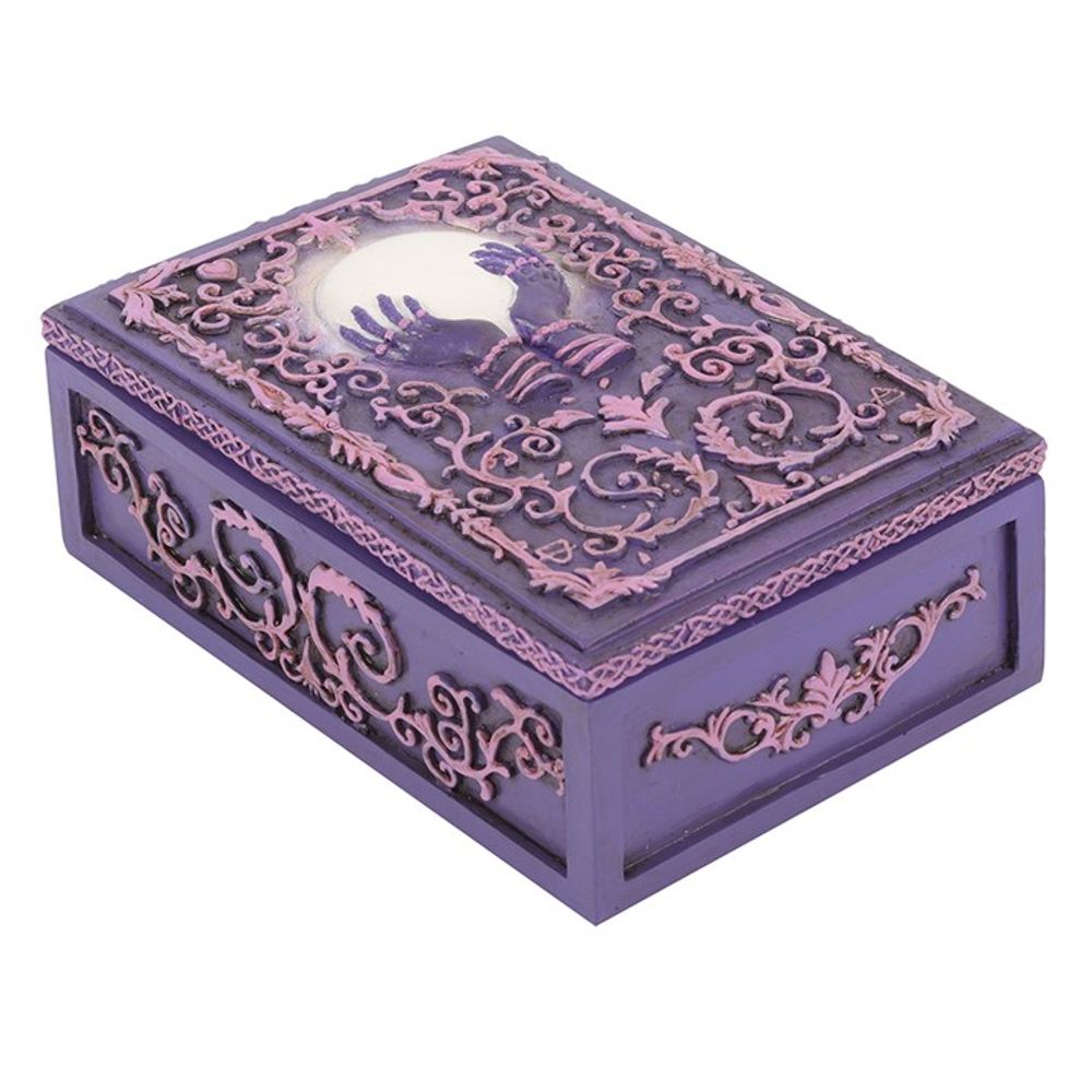 Mystical Crystal Ball Resin Storage Box  A resin box with raised filigree details and a mystical hand and crystal ball design in the center. This pink and purple style is perfect for holding small tarot card decks, crystals, herbs and other small objects for safe keeping.