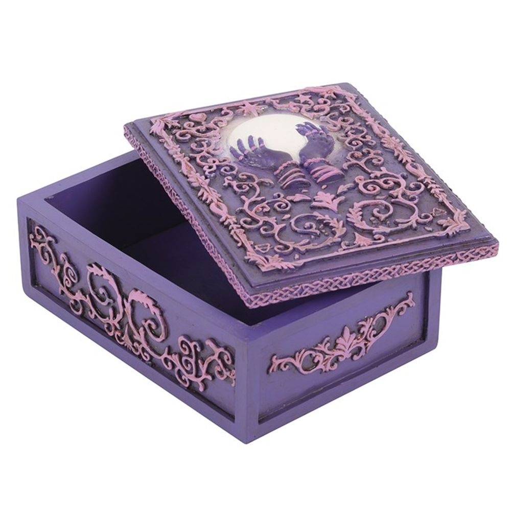 Mystical Crystal Ball Resin Storage Box  A resin box with raised filigree details and a mystical hand and crystal ball design in the center. This pink and purple style is perfect for holding small tarot card decks, crystals, herbs and other small objects for safe keeping.