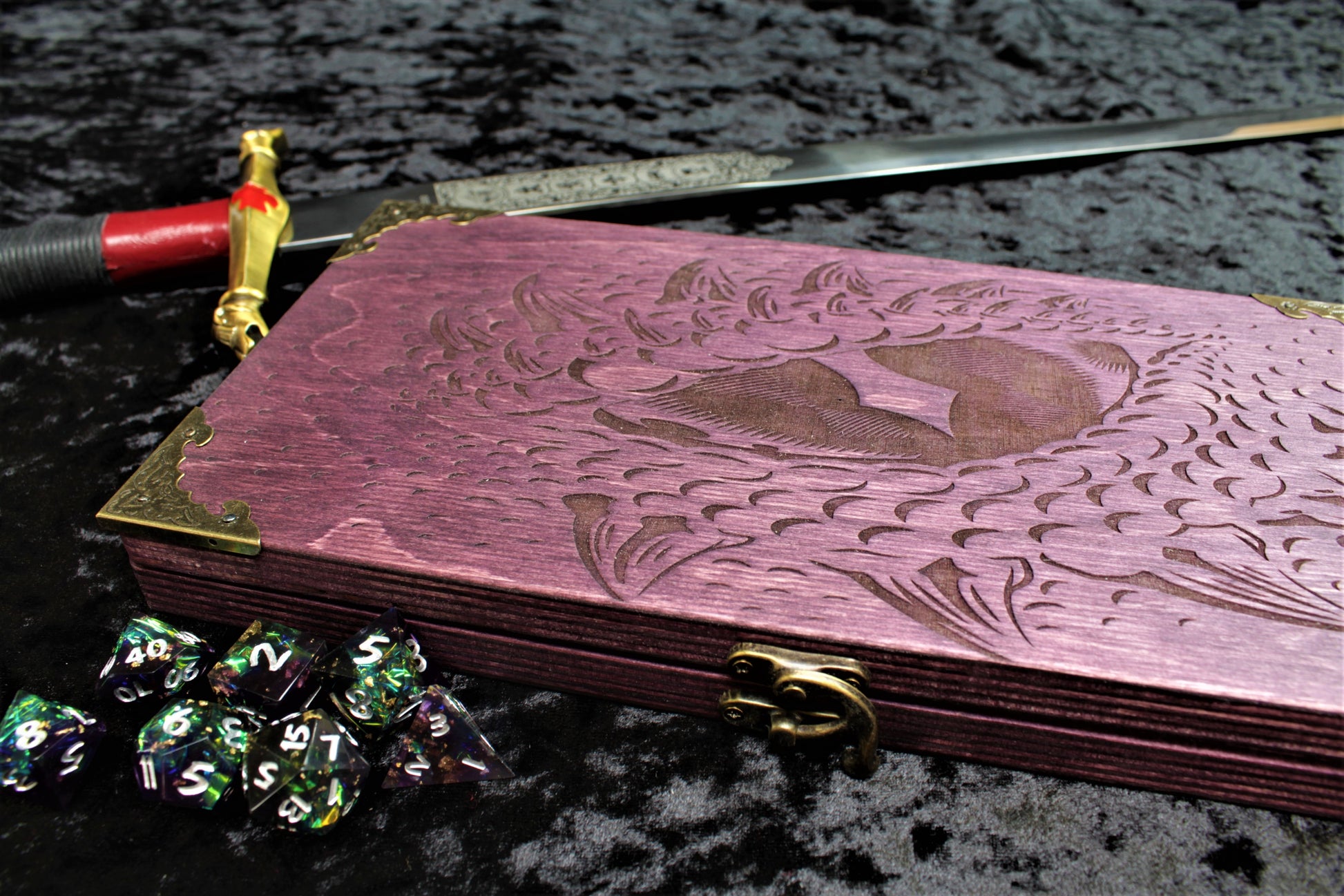 Dragon Eye Dice Box, Accessory Storage and Roll Tray.

Hand finished dice box for storing dice, cards, counters and accessories with handy pen storage and in built roll tray. Choose from 8 vibrant colour finished to make your box unique to you. Complete with our unique dragon's eye design, metal corner protectors and clasp
