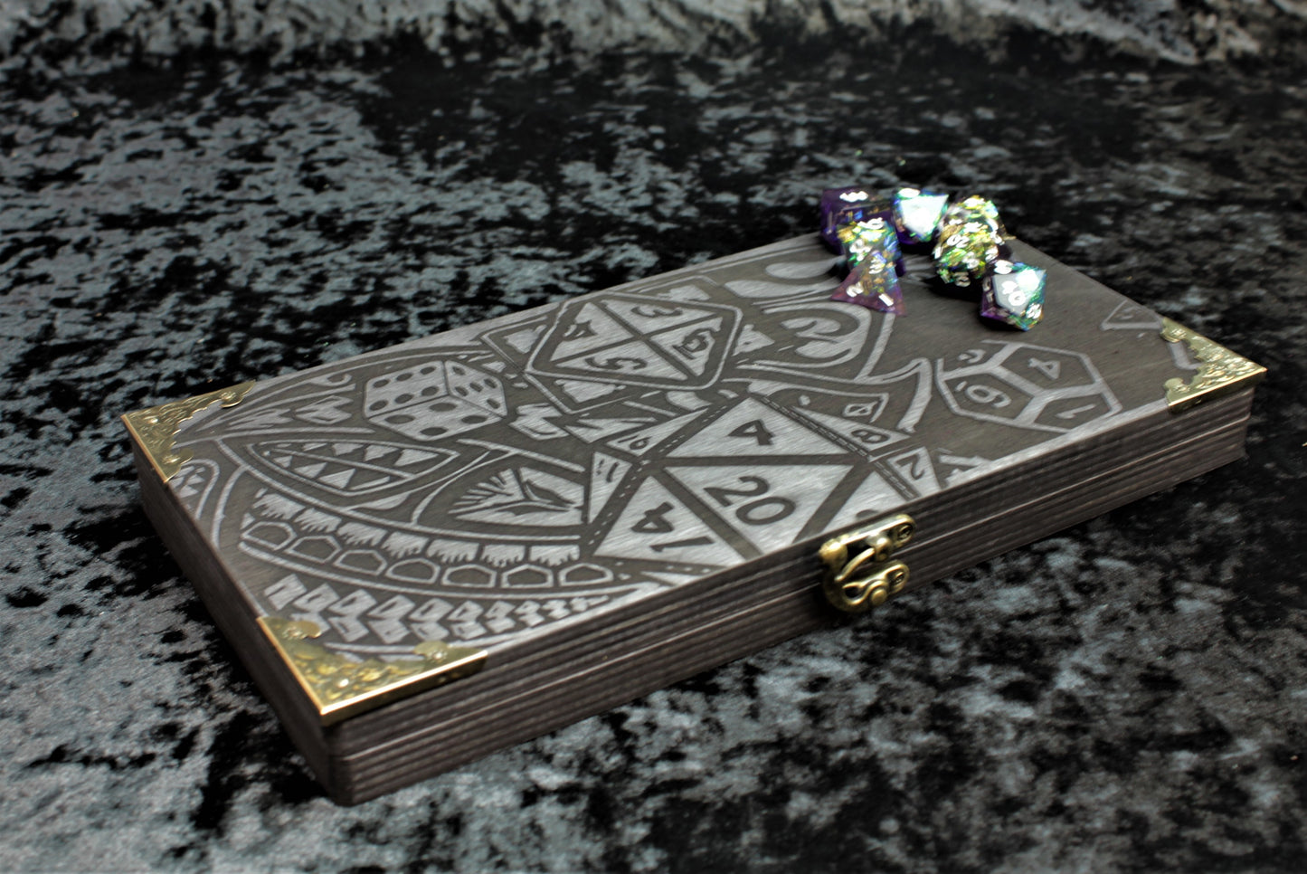 How They Fall Dice Box, Accessory Storage and Roll Tray.

Hand finished dice box for storing dice, cards, counters and accessories with handy pen storage and in built roll tray. Choose from 8 vibrant colour finished to make your box unique to you. Complete with our unique&nbsp;falling dice design, metal corner protectors and clasp