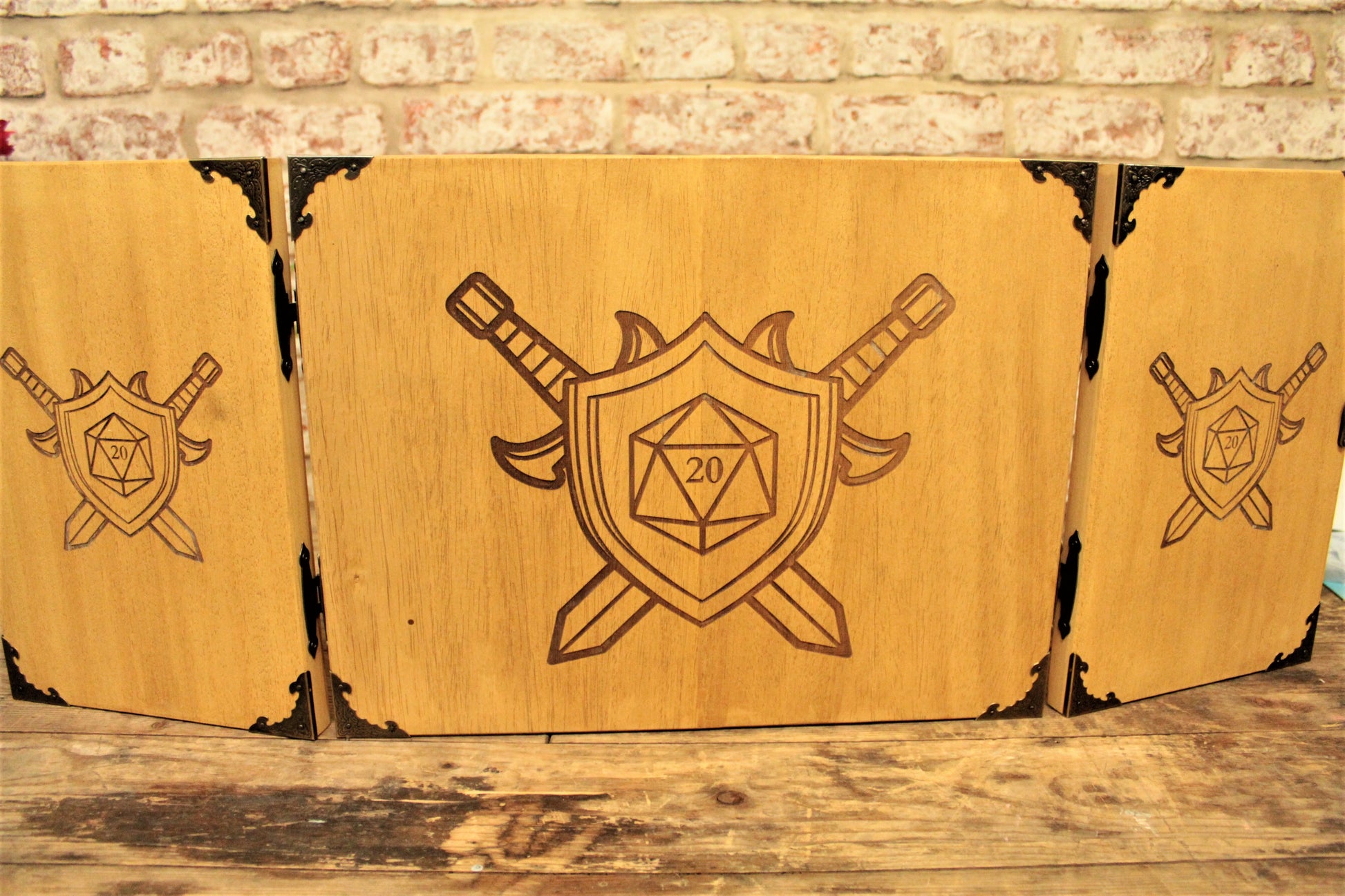 An impressive, budget friendly addition to your RPG setup. Featuring Fandomonium's ever-popular D20 Sigil design, the screen's 3 sections fold on hinges and has an antique effect catch for easy storage. The finish is aged and antiqued by hand to give you that rustic, tavern feel. Hand made by Fandomonium